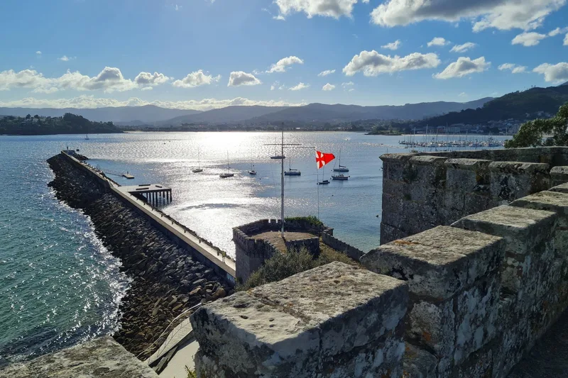 Stone battlements of the Parador de Baiona fortress overlooking the bay in Galicia
