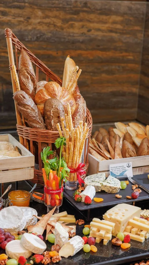 An enticing selection of bread and cheese with fruits and vegetables, perfect for catering.