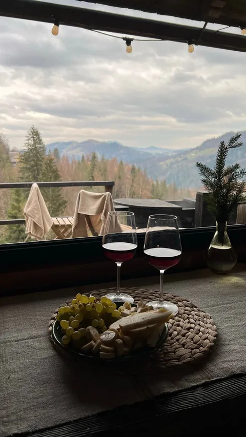 Parador terrace with red wine and snacks overlooking a valley in Spain