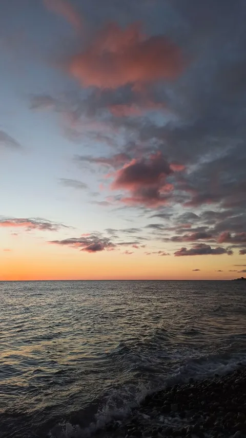 Beautiful sunset over the Black Sea in Sochi, Russia, with vibrant colors and dramatic clouds.