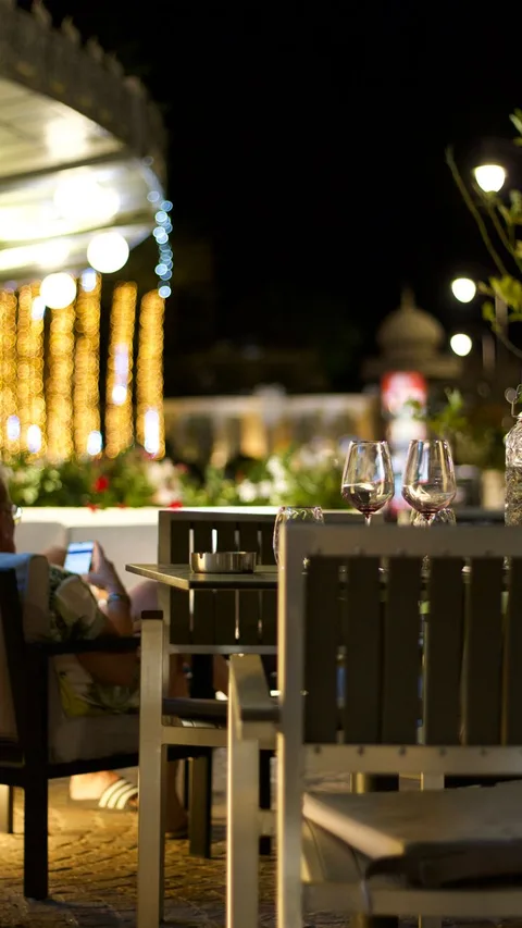 Evening terrace tables with wine glasses at Parador de Granada