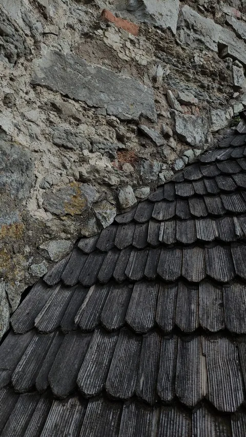 Stone wall and wooden shingle roof detail at Parador de Toledo