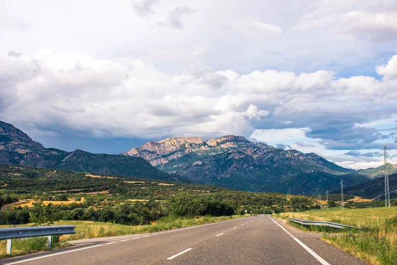 Scenic open road leading toward mountains in Spain